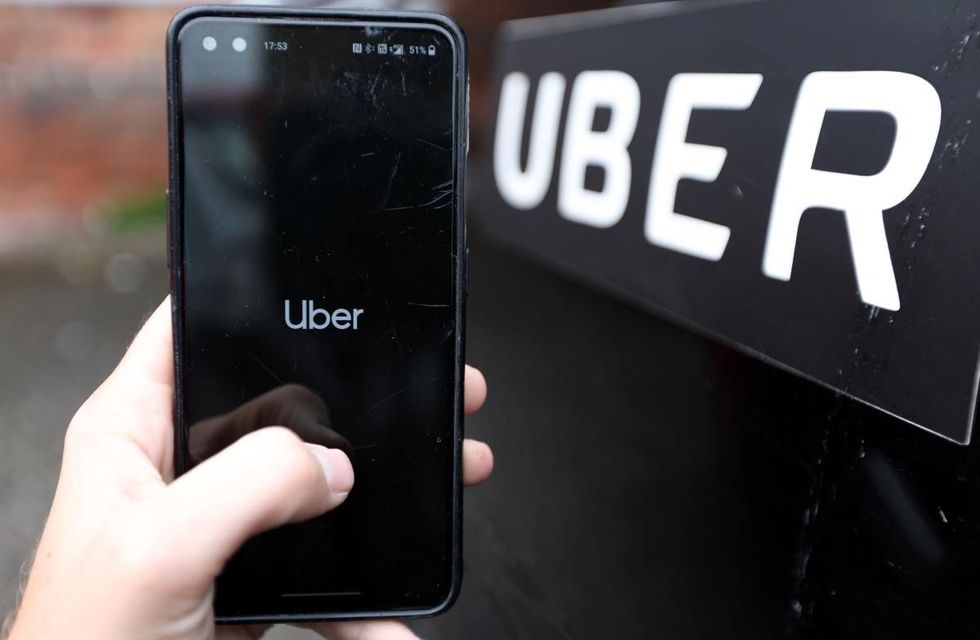 Representative Image Source: A phone is held next to a Uber car displaying the Uber app on July 22, 2023 in England . (Photo by Nathan Stirk/Getty Images)