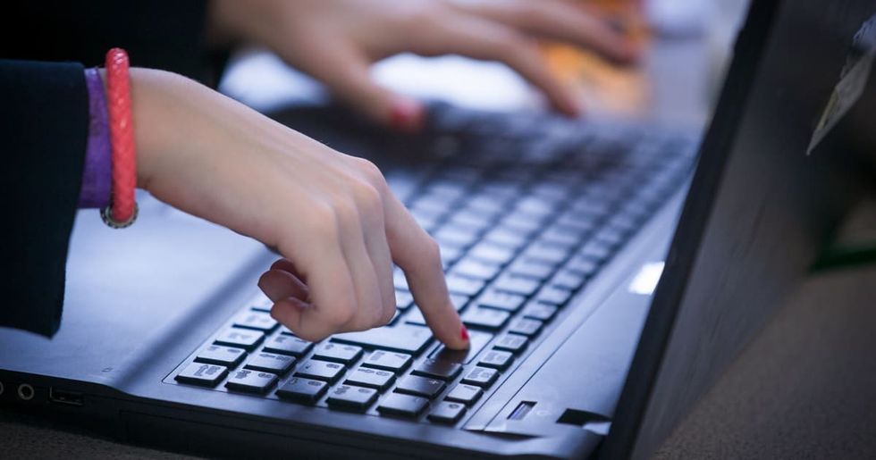 Representative Image Source: A school pupil types on a laptop keyboard as they look at the screen on February 26, 2015 in Bristol, England. (Photo by Matt Cardy/Getty Images)