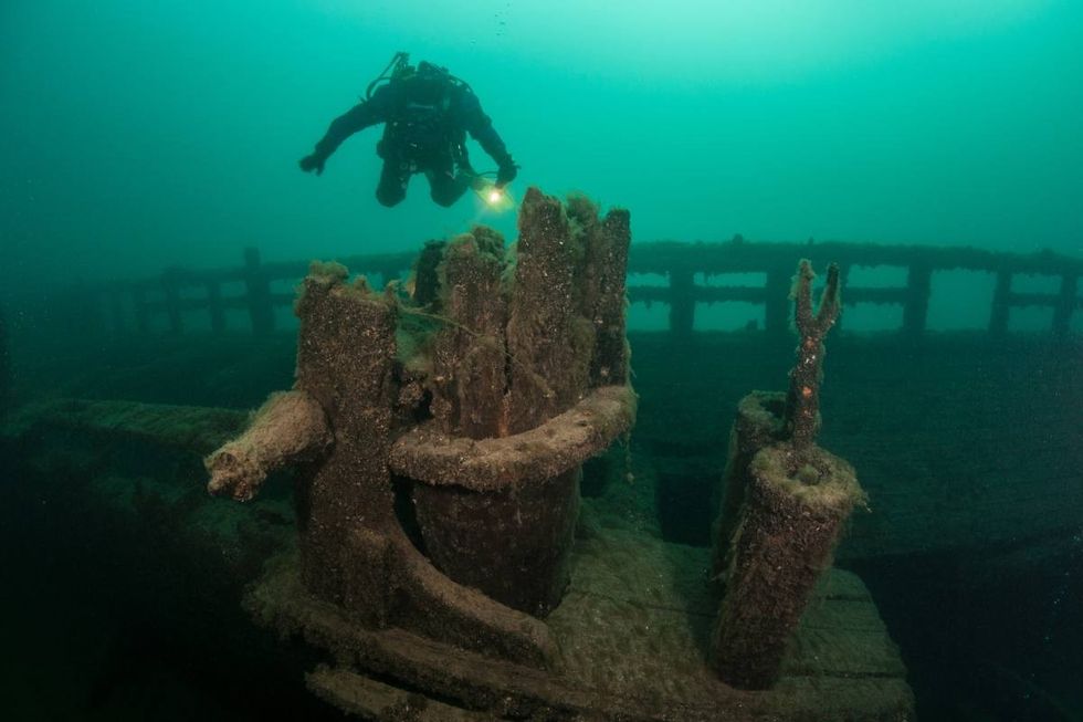 Representative Image Source: A scuba diver explores an old, wooden shipwreck in Lake Michigan. The waters of the Great Lakes are so cold that they preserve the many wrecks on bottom. (Getty Images)