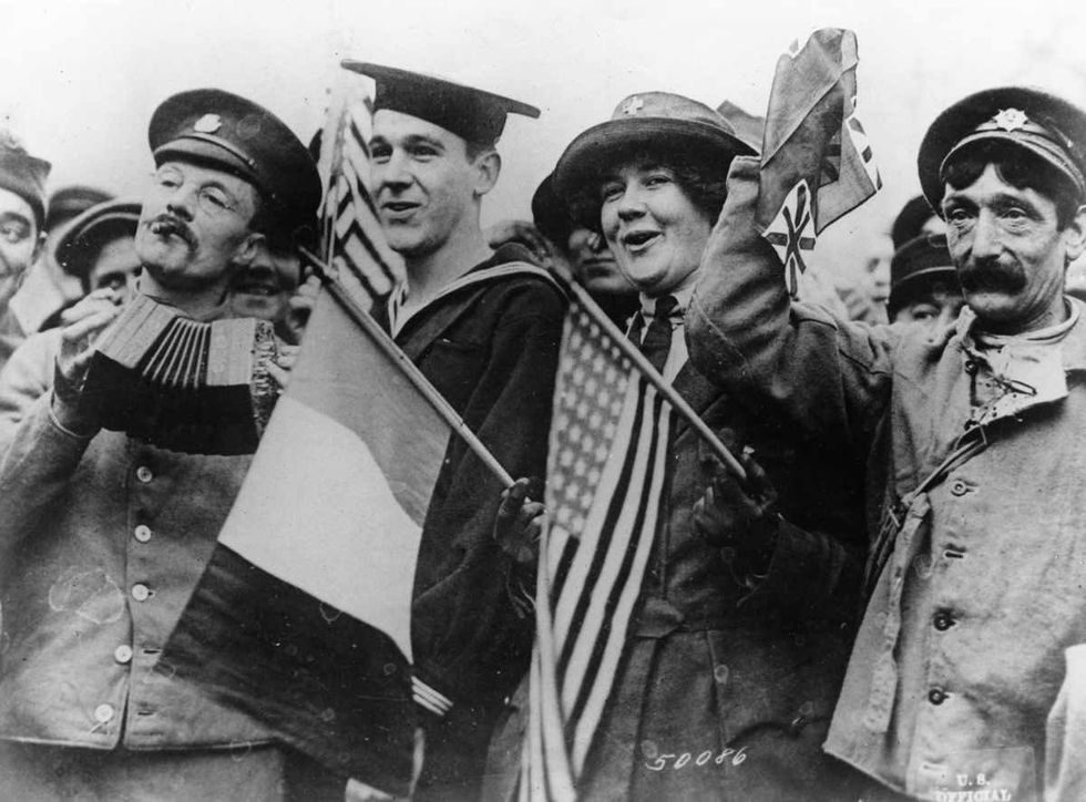 Representative Image Source: A US sailor, a French soldier and a red cross worker celebrate the signing of the Armistice ending World War I, Paris, France, November 11, 1918. (Photo by Henry Miller/FPG/Hulton Archive/Getty Images)