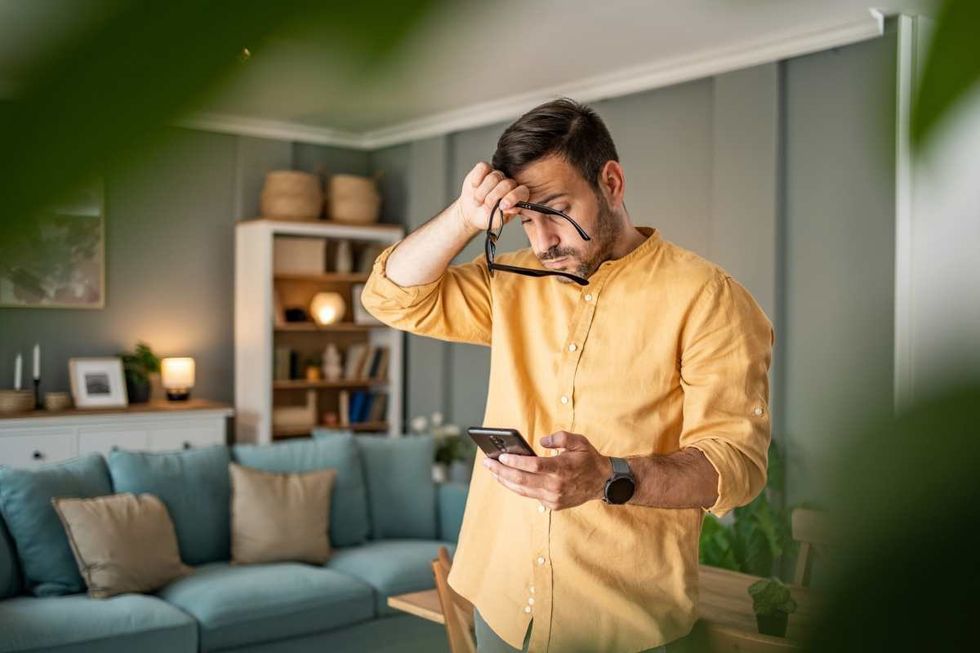 Representative Image Source: A young man is feeling depressed and thinking about the bad news he is reading online through his smartphone (Getty Images)