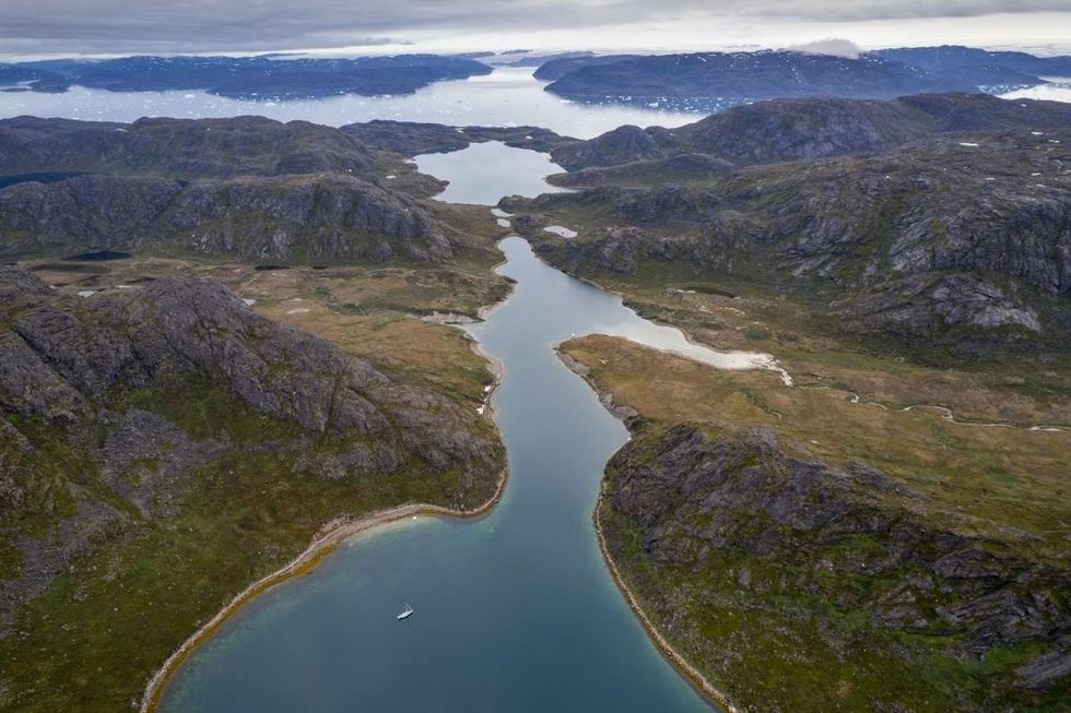Representative Image Source: Greenland, Sildefjord, Aerial view of expedition yacht S/V Ocean View anchored in cove along Tugtotoq Island along Skovfjord on summer evening (Getty Images)