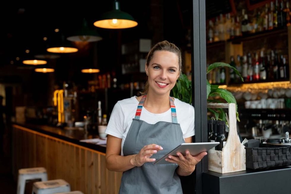 Representative Image Source: Happy waitress working at a cafe using a tablet computer and looking at the camera smiling (Getty Images)