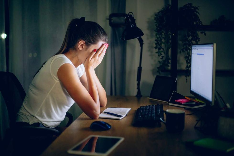 Representative Image Source: Overworked young woman at her desk late at night (Getty Images)