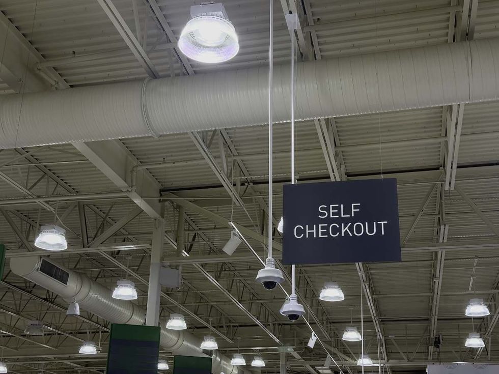 Representative Image Source: Self-checkout sign hanging from the ceiling of an unidentified suburban supermarket. (Getty Images)