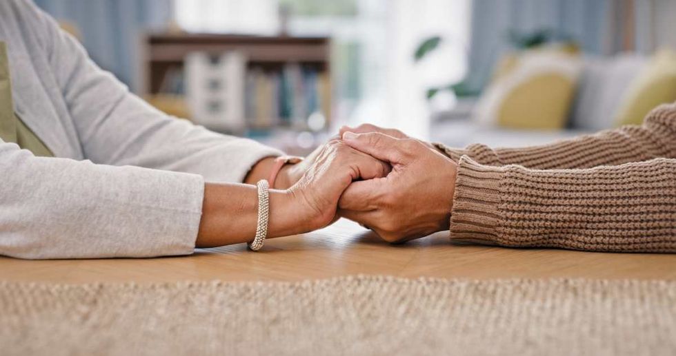 Representative Image Source: Senior couple, holding hands and closeup on table for care love or retirement support, compassion or trust. (Getty Images)
