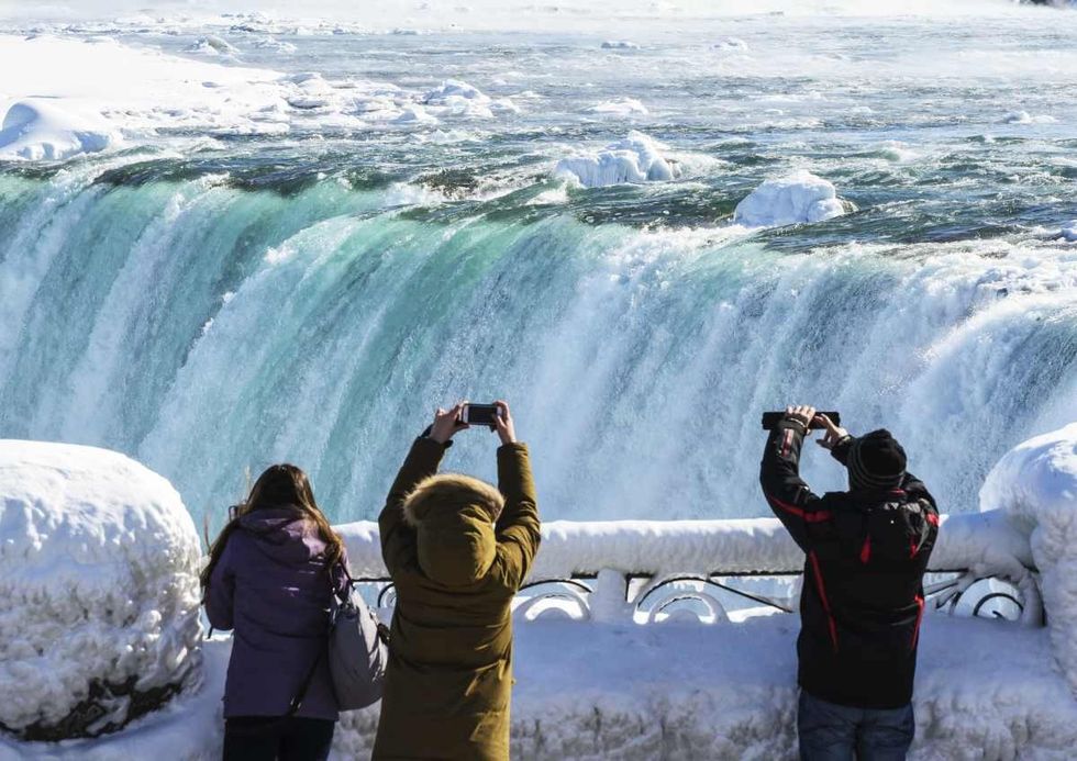 Representative Image Source: Sightseers take pictures of a nearly frozen Niagara Falls on February, 20 2015 in Niagara Falls, Ontario, Canada. (Photo by Aaron Vincent Elkaim/Getty Images)