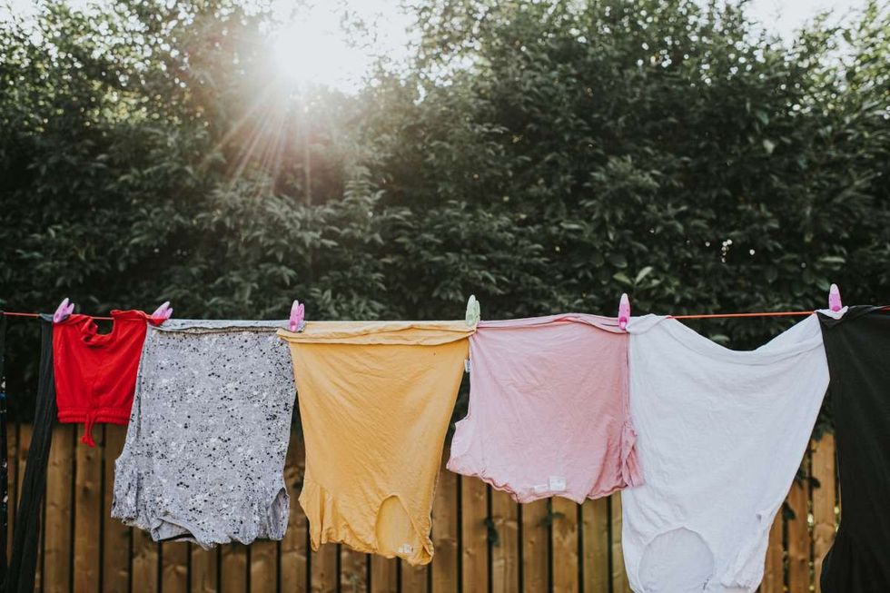 Representative Image Source: Various colours and sizes of clothing hanging in a row on a washing line outside, attached to the line with plastic clothes pegs. (Getty Images)