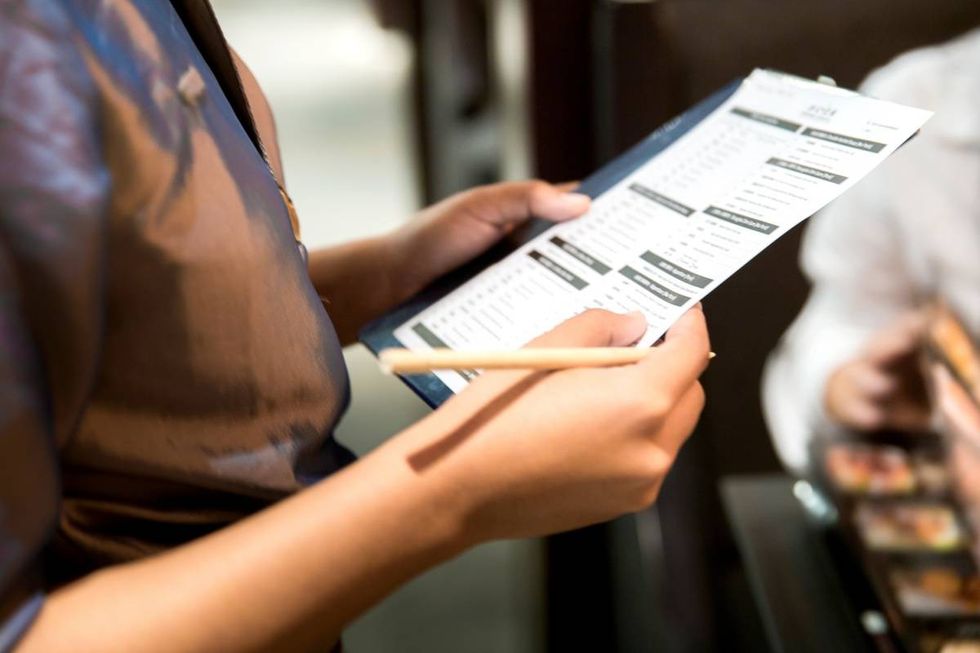 Representative Image Source: Waitress writing a food order, customer selecting food and drinks (Getty Images)