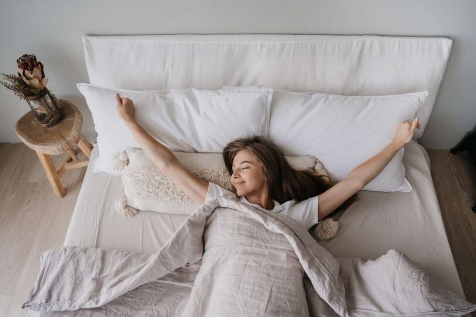 Representative Image Source: Young long haired Italian girl laying on bed eyes closed awakening at Sunday morning smiles satisfied by healthy sleep. (Getty Images)