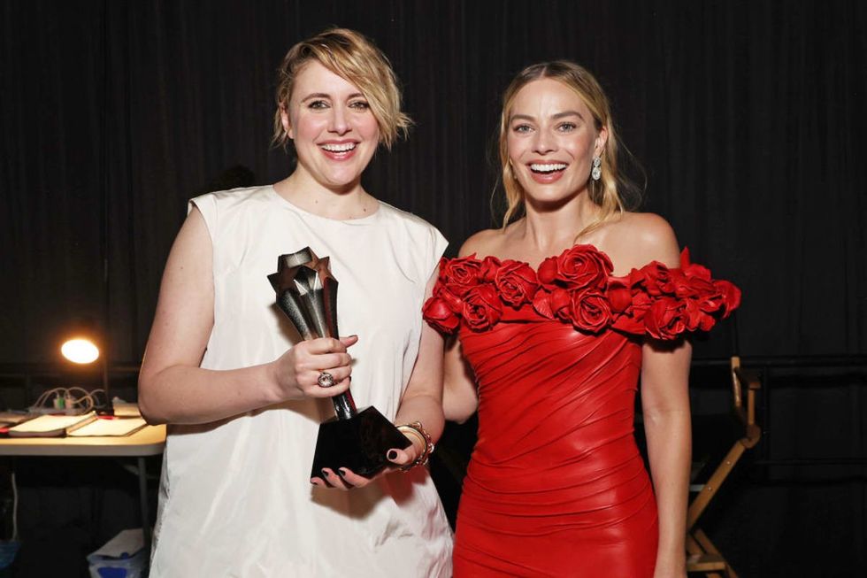SANTA MONICA, CALIFORNIA - JANUARY 14: (L-R) Greta Gerwig and Margot Robbie, winners of the Best Comedy Award for 'Barbie,' pose backstage during the 29th Annual Critics Choice Awards at Barker Hangar on January 14, 2024 in Santa Monica, California. (Photo by Kevin Mazur/Getty Images for Critics Choice Association)