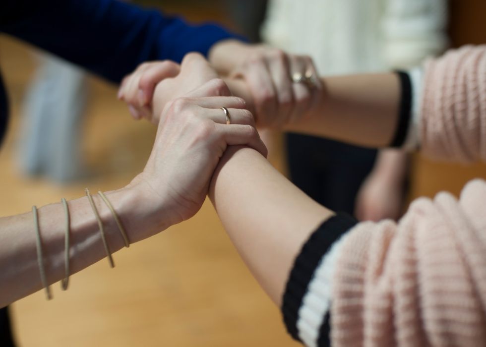two people grasping hands