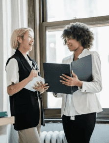 Two women talk in the office