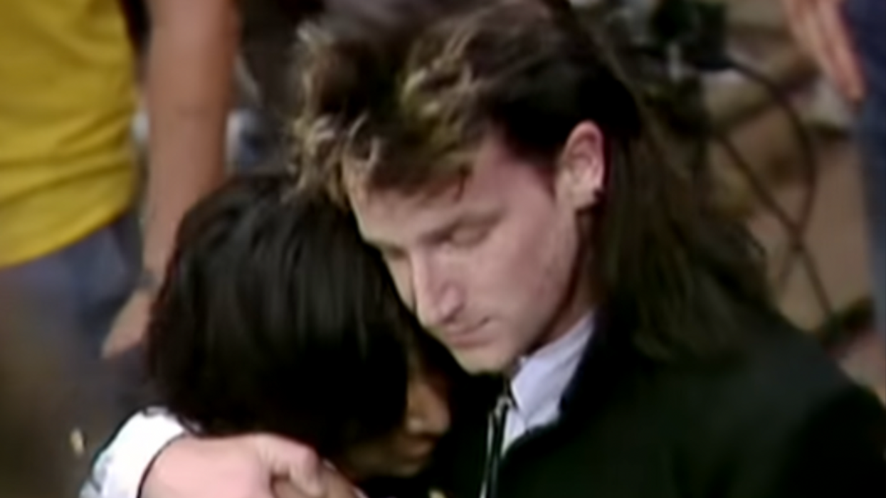 U2, singer, Bono, embraces, fan