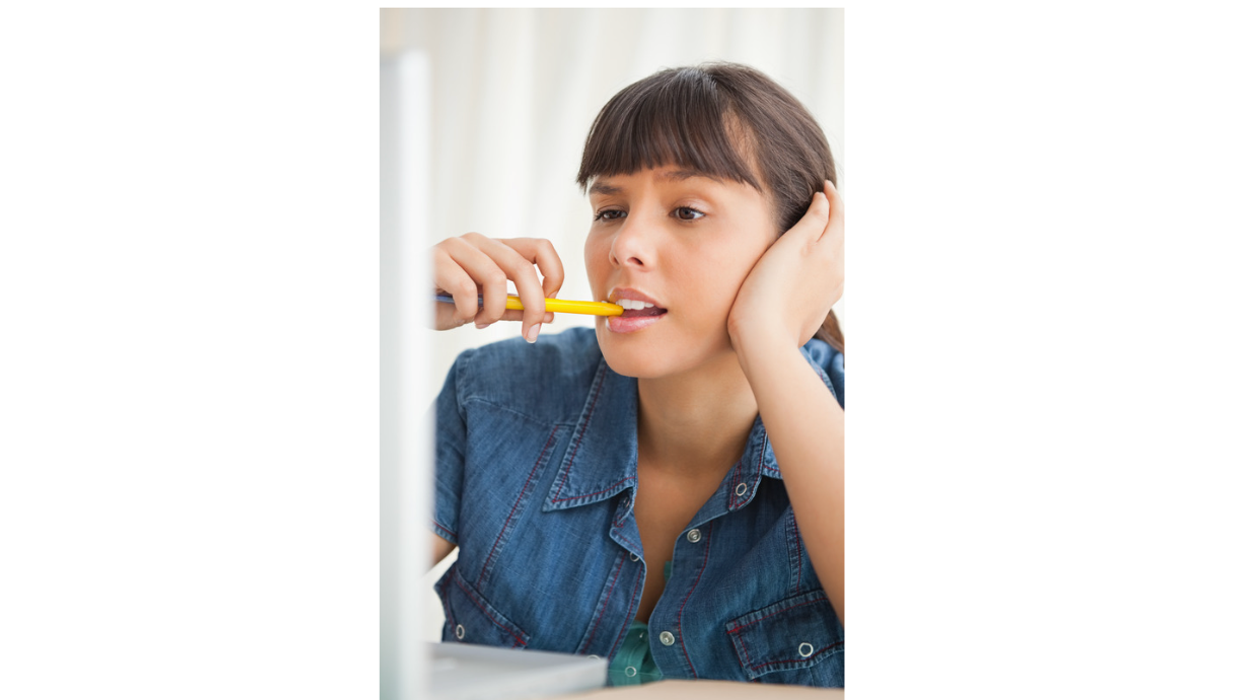 Woman chewing on pencil