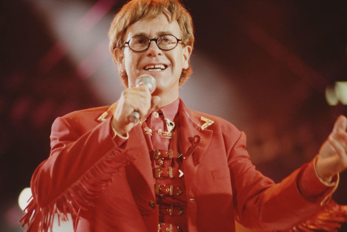 English singer and musician Elton John performing on stage during the Freddie Mercury Tribute Concert for Aids Awareness at Wembley Stadium in London on the 20th April, 1992. (Photo by Michael Putland/Getty Images)