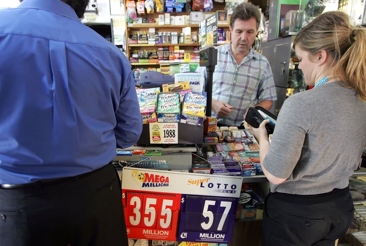 Image Source:  Liquor store clerk Les English (C) sells Mega Millions lottery tickets March 6, 2007 in San Francisco, California. (Photo by Justin Sullivan/Getty Images)