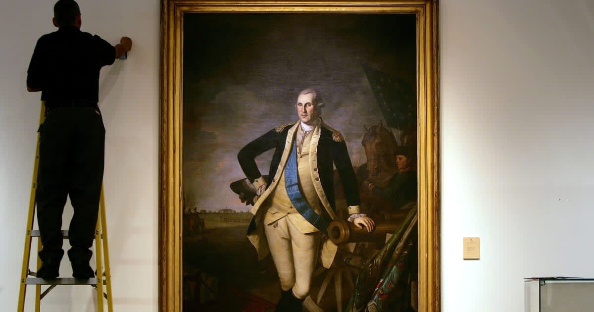 A worker uses a ladder to work near a full length portrait of former U.S. President George Washington, by Charles Wilson Peale, at Christie's auction house January 17, 2006 in New York City.(Photo by Spencer Platt/Getty Images)