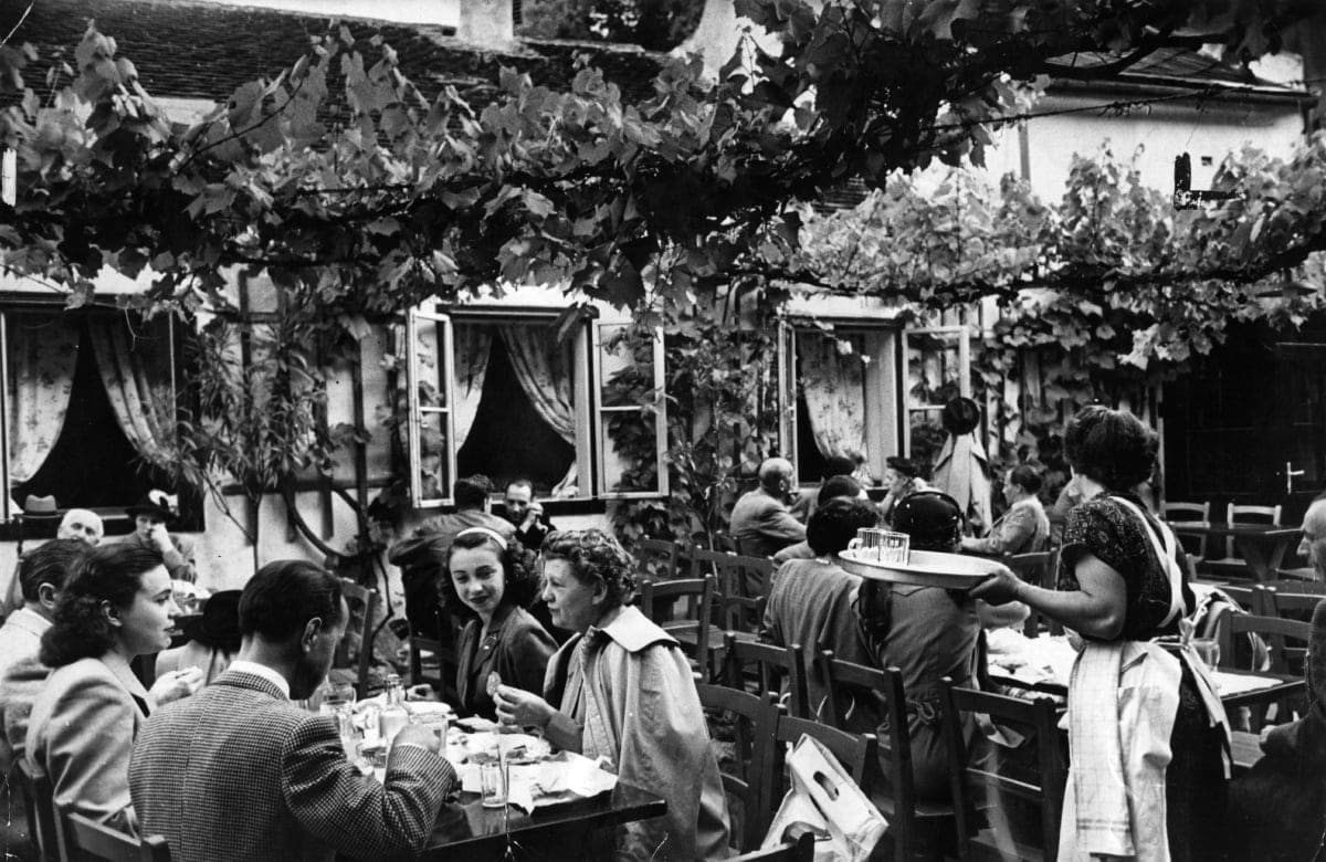 Image Source: People seated in the wine gardens at Beethoven's House, Vienna. (Photo by Kurt Hutton/Picture Post/Hulton Archive/Getty Images)