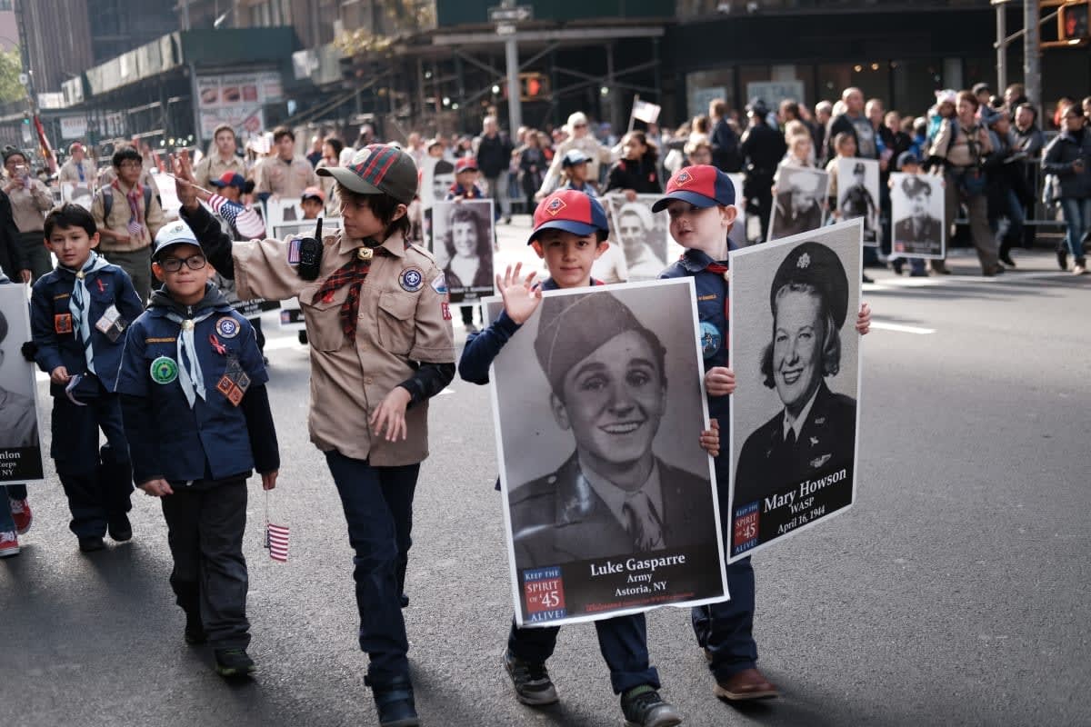 Image Source:  Boy Scouts carry pictures of veterans during the Veterans Day Parade on November 11, 2019 in New York City. (Photo by Spencer Platt/Getty Images)