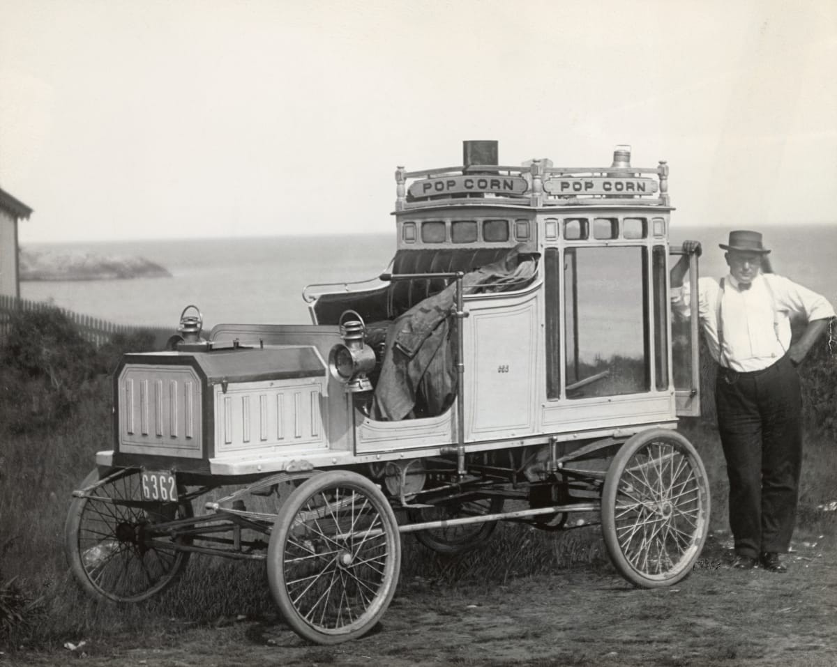 Image Source: Portrait of Early Popcorn Vendor Next to His Automobile
