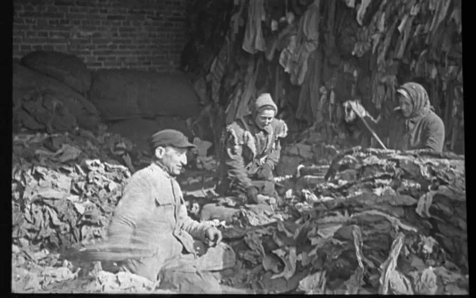 Sorting through belongings left after deportation.