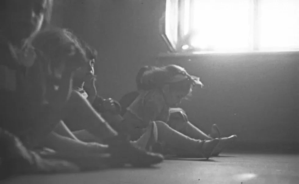 Children sitting on the floor.