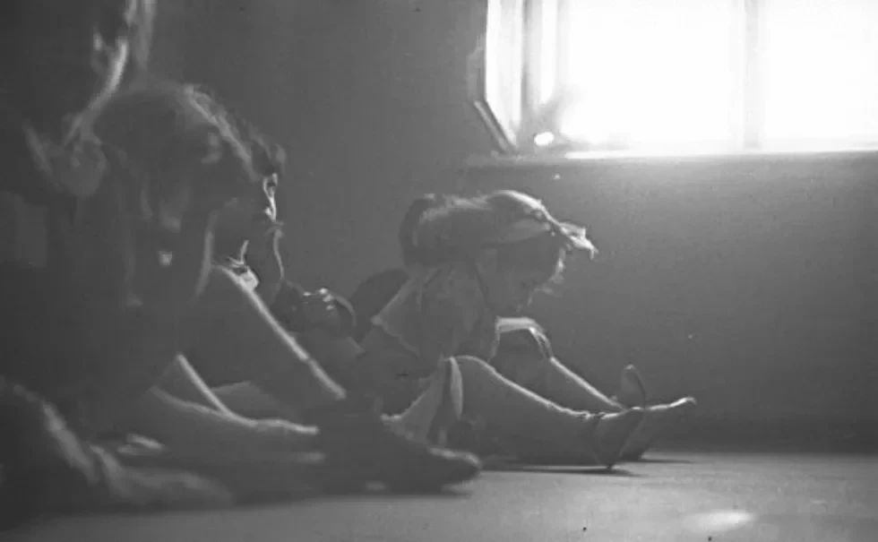 Children sitting on the floor.