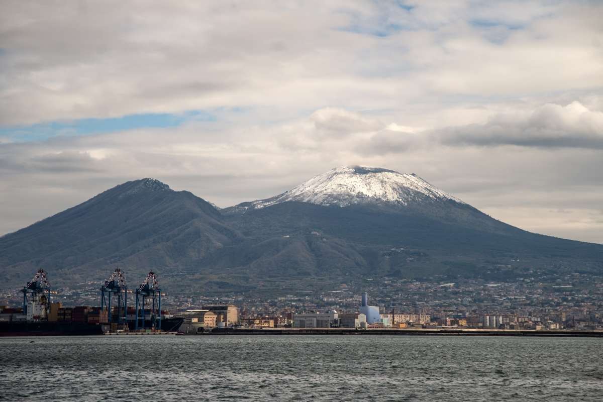Image Source: Mount Vesuvius is capped with snow as seen from the Maritime Station on March 20, 2021 in Naples, Italy. (Photo by Ivan Romano/Getty Images)