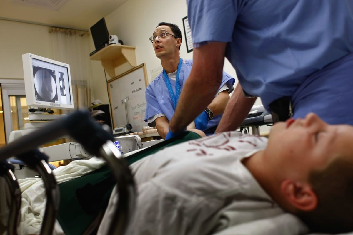Representative Image Source: Physician's Assistant in the emergency room of the non-profit Children's Hospital in Aurora, Colorado. (Photo by John Moore/Getty Images)