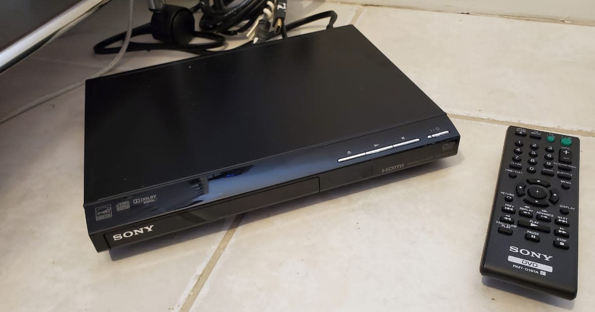 Representative Image Source: High-angle shot of a black Sony DVD player and remote, with Sony, Dolby, and HDMI logos, resting on a white tiled floor with cords and a media cart in the background, October 31, 2022. Photo courtesy Sftm. (Photo by Gado/Getty Images)