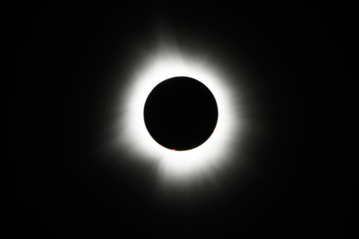 Image Source: he Moon crosses in front of the Sun during a total solar eclipse at Lake Monroe on April 08, 2024 in Indiana, United States. (Photo by Edward M. Pio Roda/Getty Images)