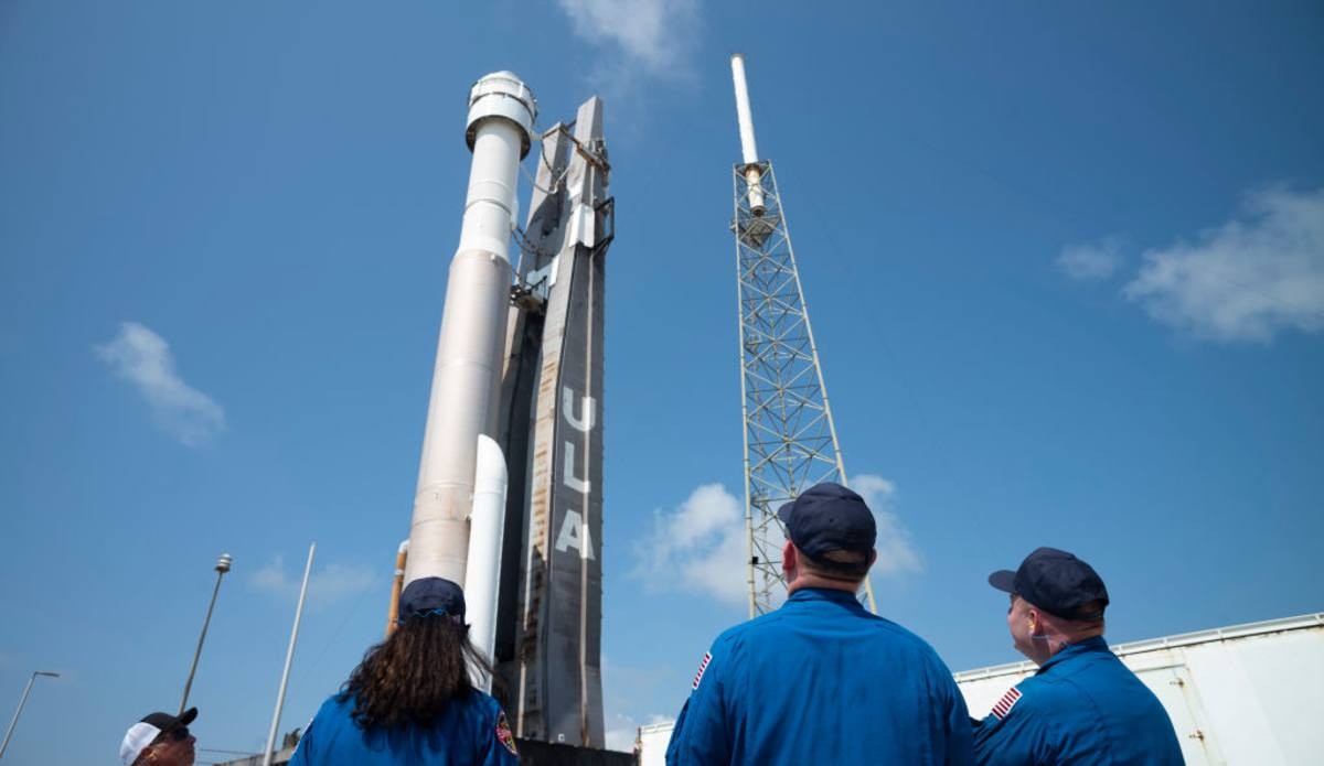 Image Source: NASA astronauts Suni Williams, Barry Wilmore, and Mike Fincke watch as Boeings Starliner spacecraft is rolled out to the launch pad at Space Launch Complex 41 ahead of the Orbital Flight Test-2 mission in Cape Canaveral, Florida.