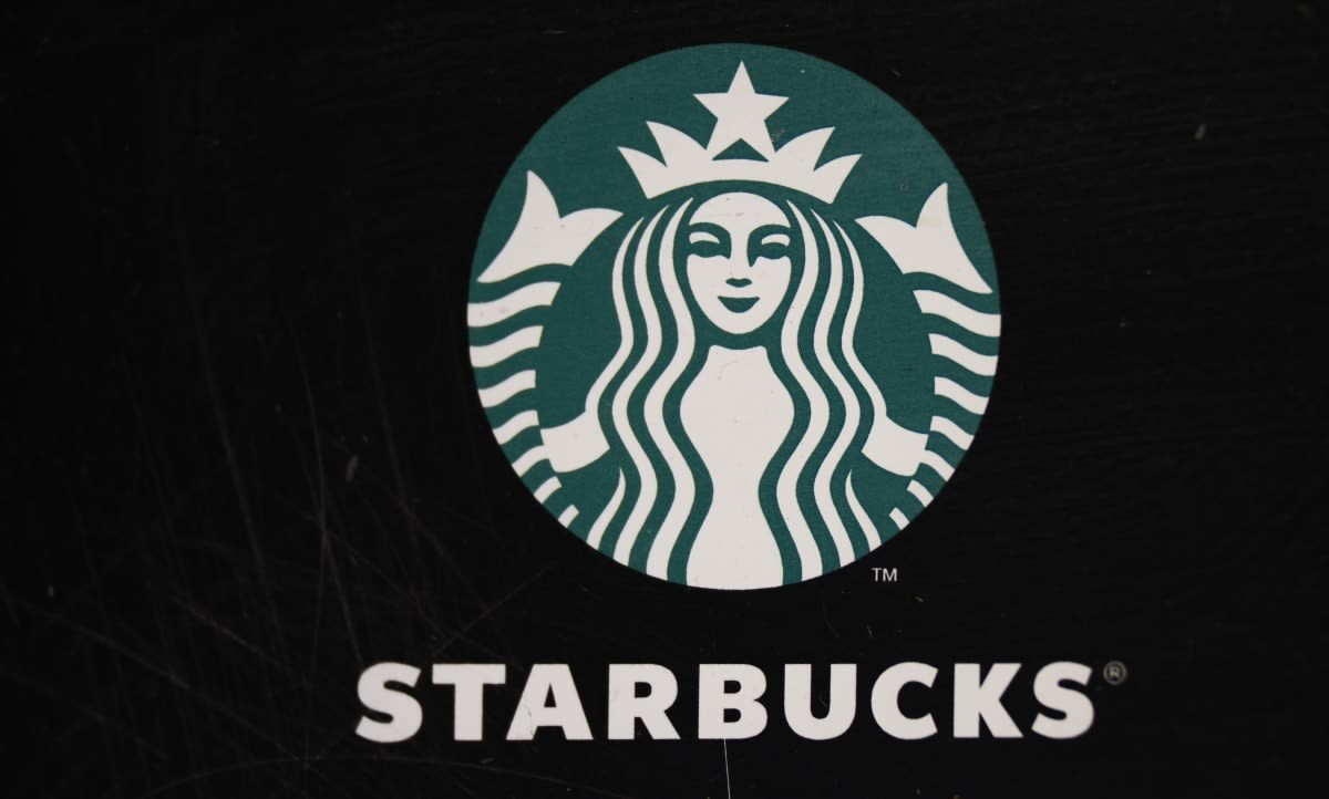 Image Source: Starbucks Cafe logo at Rua dos Clerigos on March 23, 2024, in Porto, Portugal. (Photo by Horacio Villalobos#Corbis/Corbis via Getty Images)