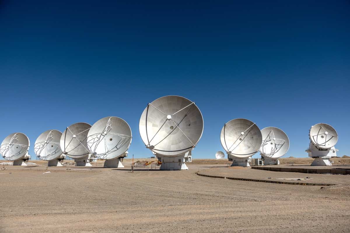 Image Source: Massive antennas, part of the Atacama Large Millimeter/submillimeter Array (ALMA) radio telescope, stand in position on August 26, 2022 on the Chajnantor Plateau of northern Chile. (Photo by John Moore/Getty Images)