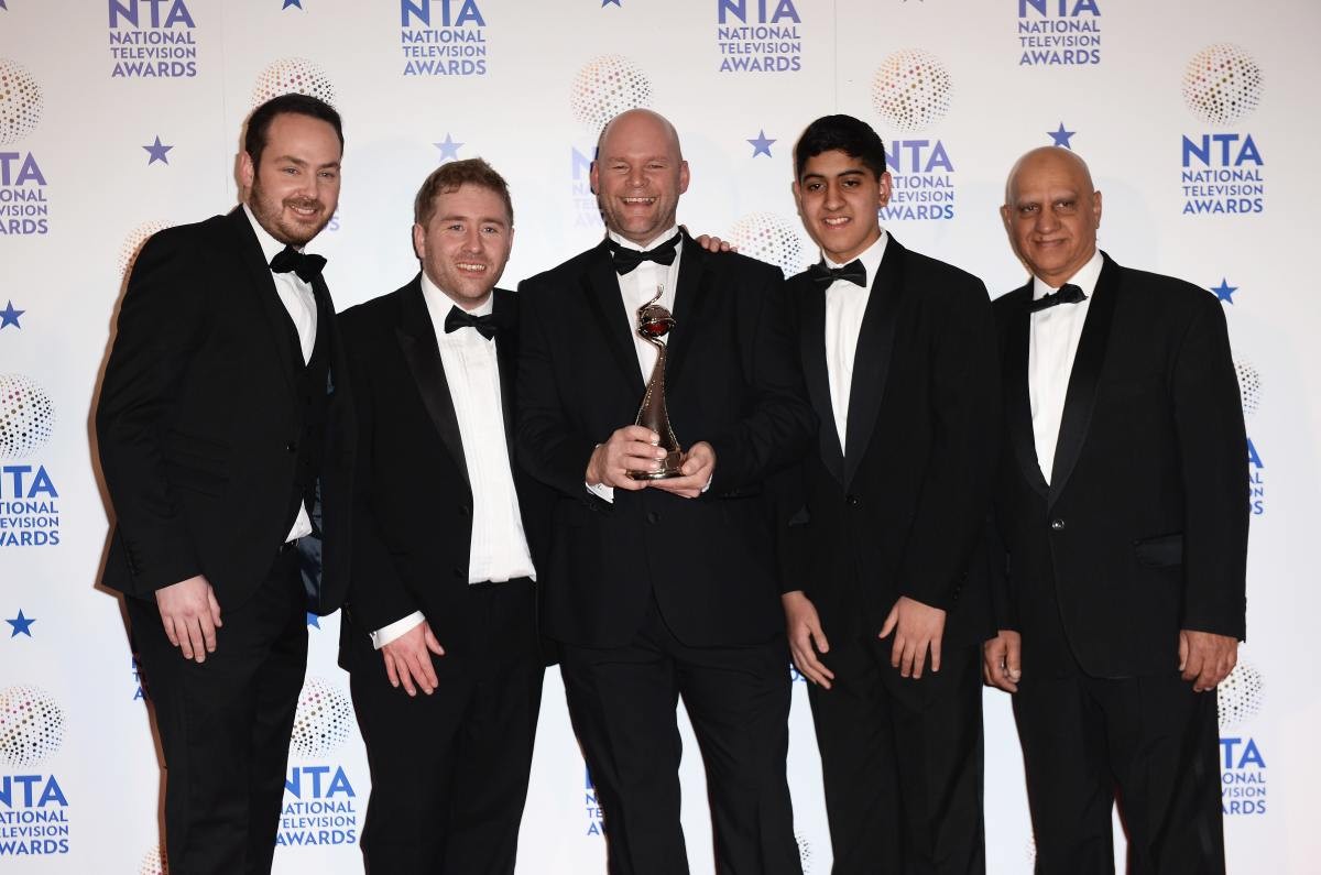 Image Source: Jonny Mitchell (C), Matthew Burton (L), Michael Steer (2ndL) and Musharaf Asghar (2ndR) pose with their Best Documentary Series award for 'Educating Yorkshire' during National Television Awards 2014 in England. (Photo by Ian Gavan/Getty Images)