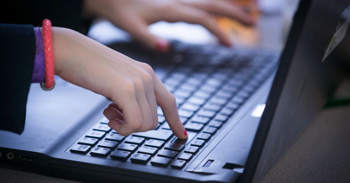 Representative Image Source: A school pupil types on a laptop keyboard as they look at the screen on February 26, 2015 in Bristol, England. (Photo by Matt Cardy/Getty Images)