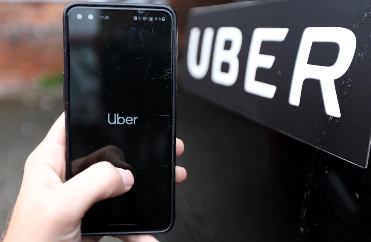 Representative Image Source:  A phone is held next to a Uber car displaying the Uber app on July 22, 2023 in England . (Photo by Nathan Stirk/Getty Images)