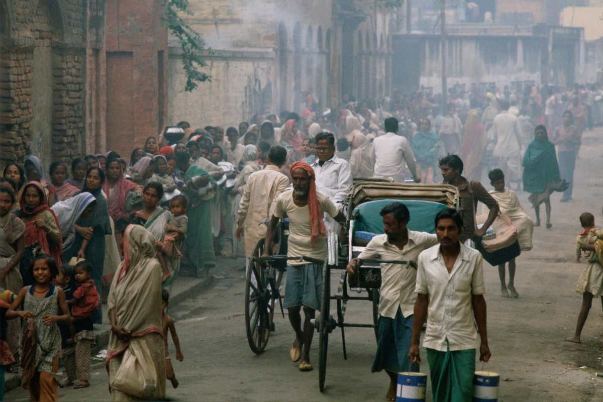 Representative Image Source: Rickshaws pass as poor people queue for food in the early morning in Calcutta, India. (Photo by Tim Graham/Getty Images)