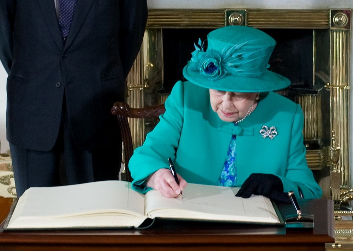 Representative Image Source: Queen Elizabeth II signs the visitors book at Aras an Uachtarain with Prince Philip. (Photo by Samir Hussein/WireImage)
