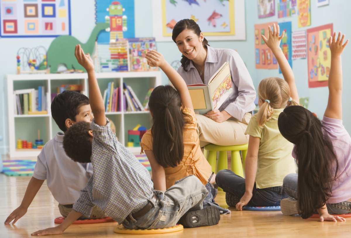 Representative Image Source: Teacher reading book in classroom, children (2-7) raising hands (Getty Images)