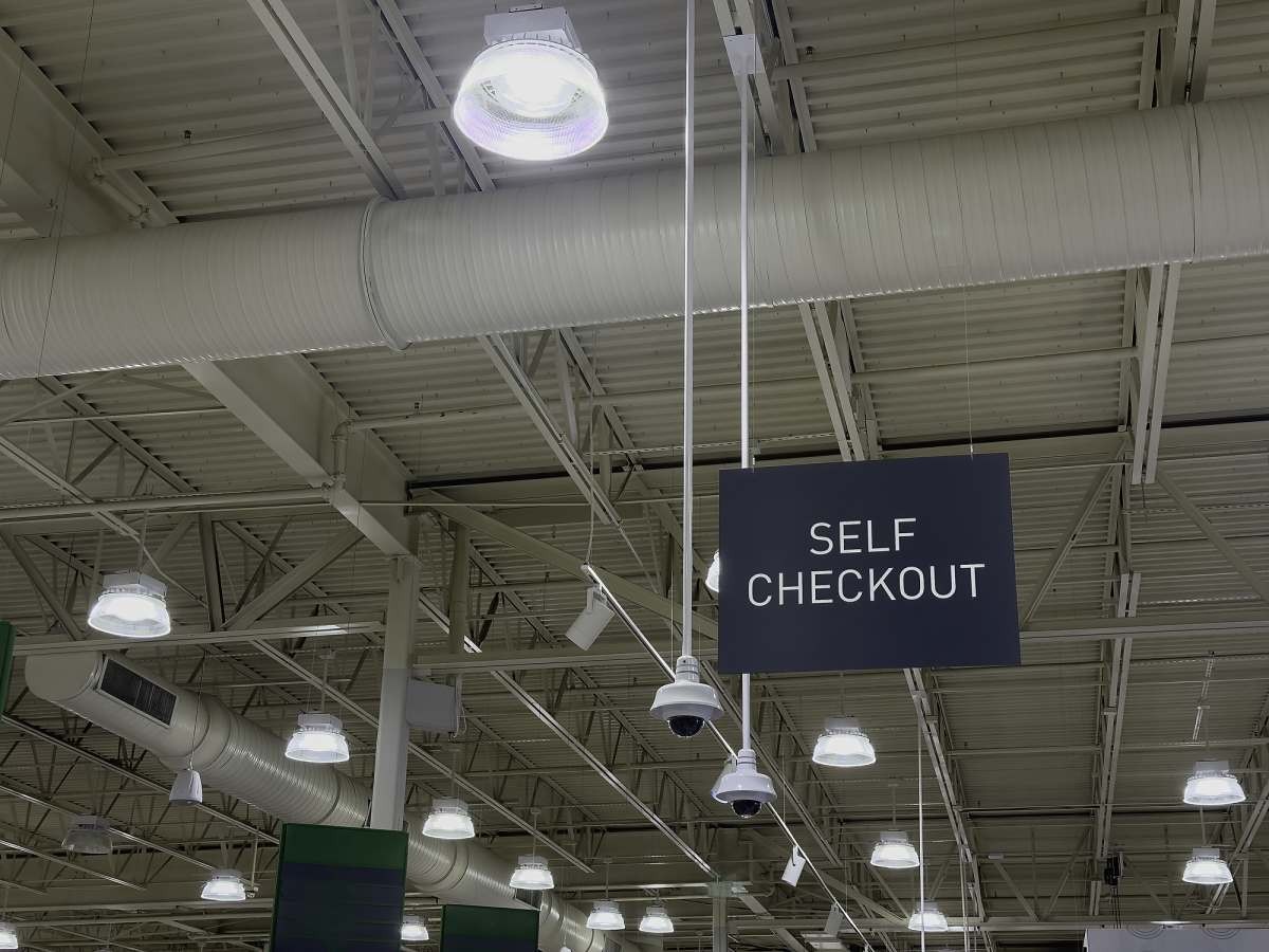 Representative Image Source: Self-checkout sign hanging from the ceiling of an unidentified suburban supermarket. (Getty Images)