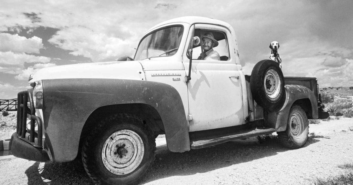 Representative Image Source: An elderly farmer in his ancient International Harvester pickup truck, with his Dalmatian dog in the bed, drives to work in the early morning, in the desert of eastern New Mexico, near Carlsbad, 1978. (Photo by Buddy Mays/Getty Images).