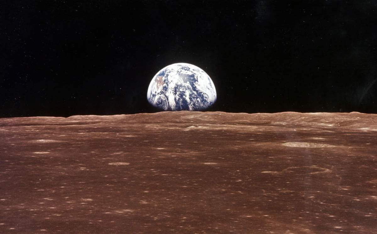 Image Source: A view of the Earth appears over the Lunar horizon (Photo by NASA/Newsmakers)
