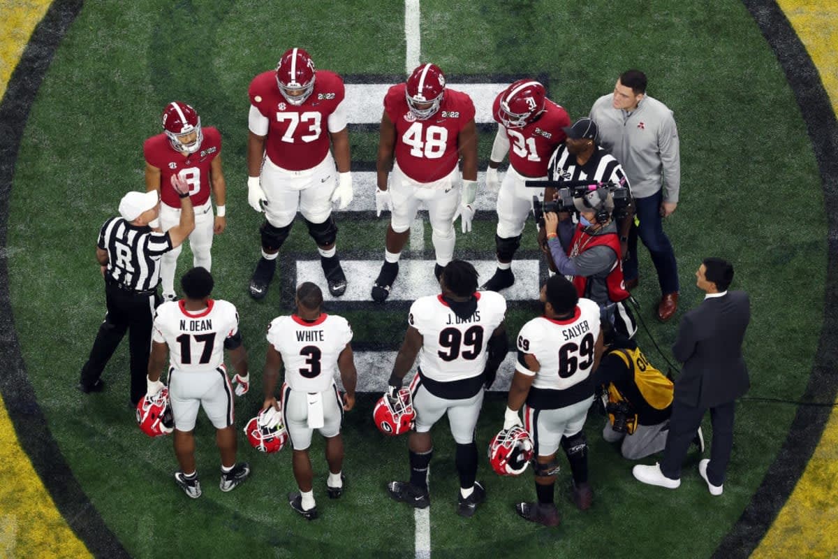INDIANAPOLIS, INDIANA - JANUARY 10: Georgia Bulldogs captains and Alabama Crimson Tide players gather at the center of the field for the coin toss before the 2022 CFP National Championship Game at Lucas Oil Stadium on January 10, 2022 in Indianapolis, Indiana. (Photo by Dylan Buell/Getty Images)