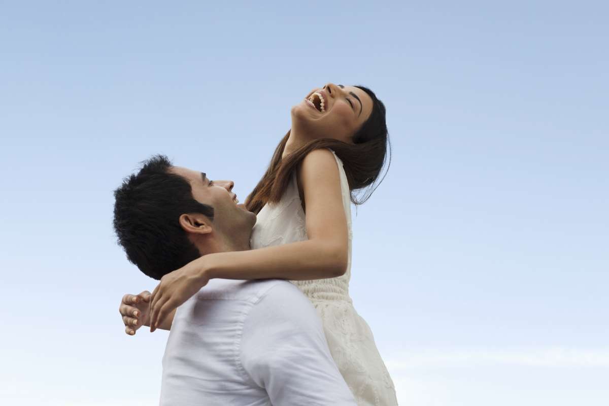 Representative Image Source: Happy young couple playing against blue sky (Getty Images)