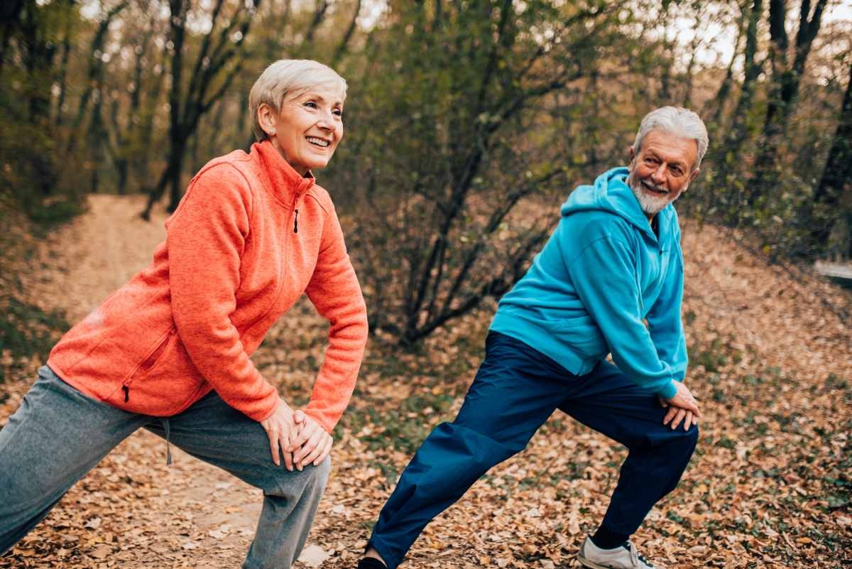Senior couple doing calf stretches in a park (Representative Image Source: Getty Images | RGStudio)