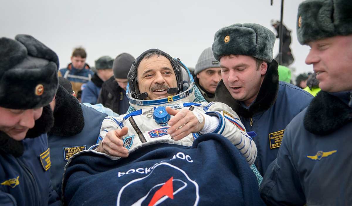 Image Source: Russian cosmonaut Mikhail Kornienko of Roscosmos is carried into a medical tent after he and Expedition 46. (Photo by Bill Ingalls/NASA via Getty Images)