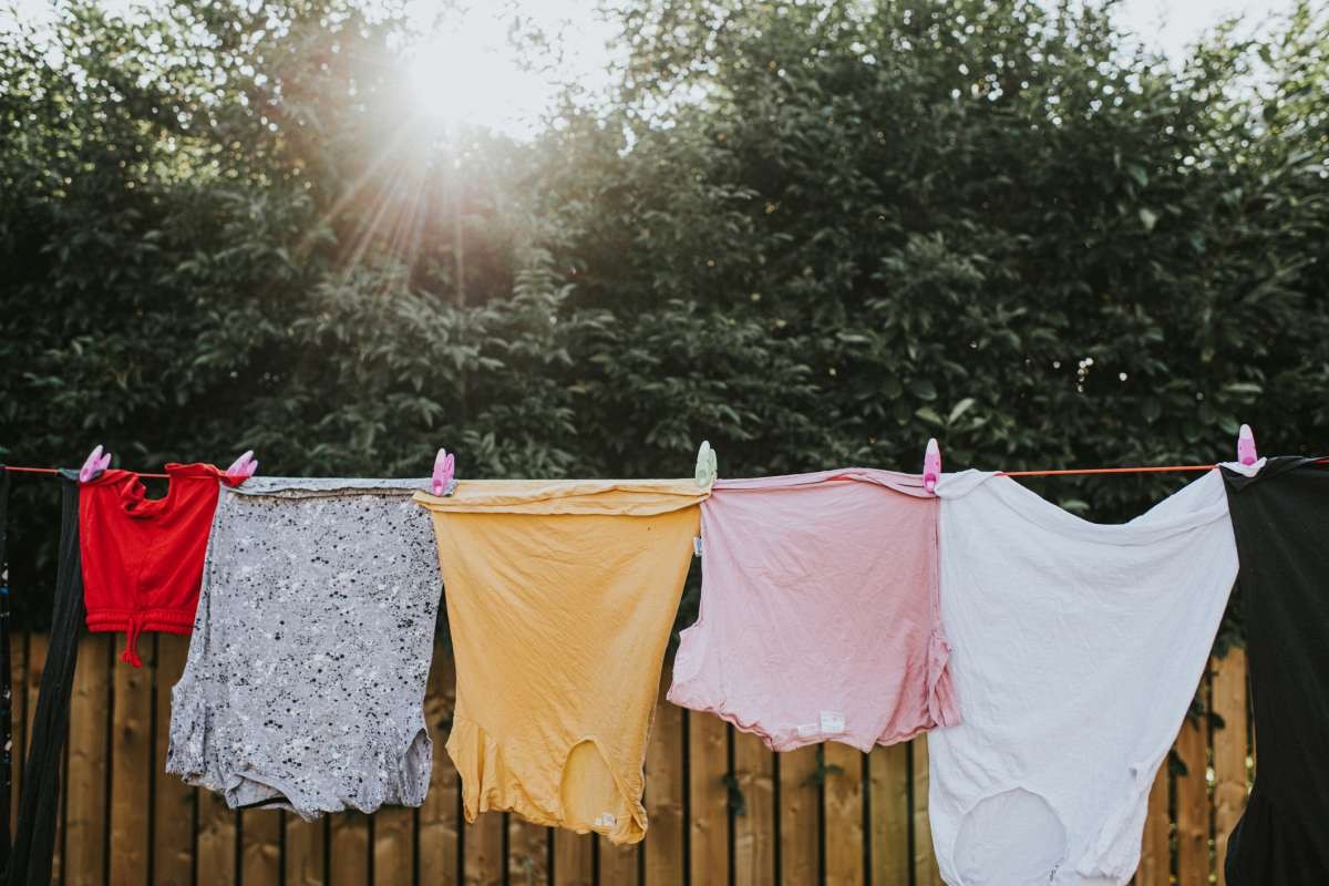 Representative Image Source: Various colours and sizes of clothing hanging in a row on a washing line outside, attached to the line with plastic clothes pegs. (Getty Images)