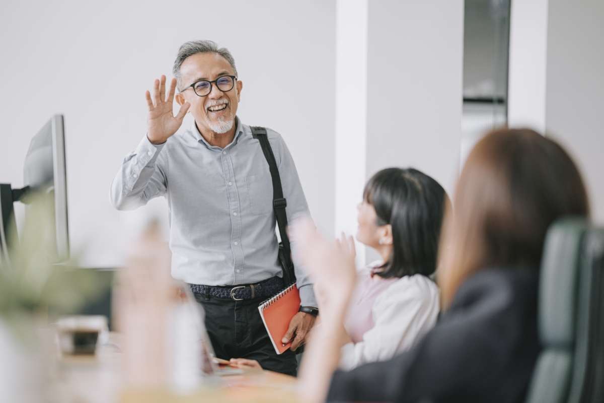 Working asian chinese senior colleague back to work with face mask greeting on each other in office morning (Representative Image Source: Getty Images | Edwin Tan)